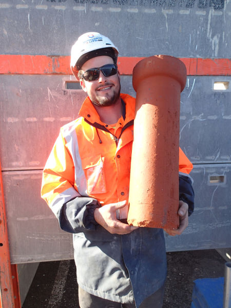 A very happy Ty Laskey from Donaldson Civil with one of these earthenware dewatering pipes we managed to recover intact. Unlike earthenware pipes for sewerage applications which are always glazed, these particular pipes were unglazed, and had been laid dry; that is to say without any cement mortar between the individual pipes to allow for the free infiltration of water. Image: Hamish Williams.