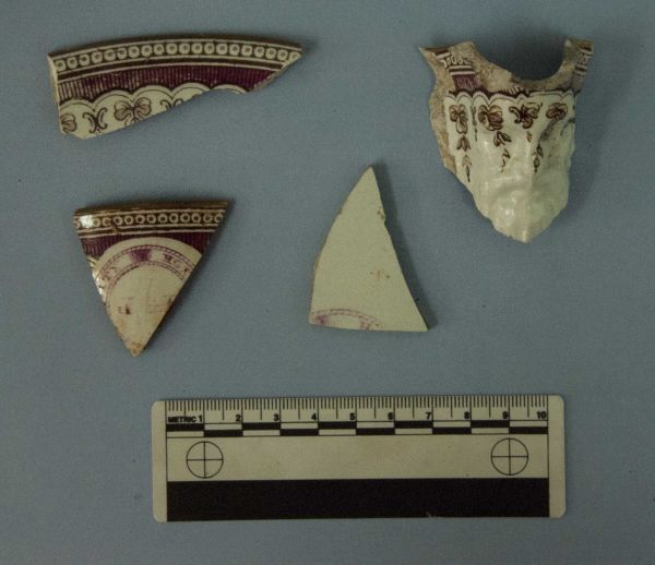 Fragments of a saucer, teacup and mask jug (with beard!), decorated with the City Hotel pattern and the initials J. G. R. Image: J. Garland.